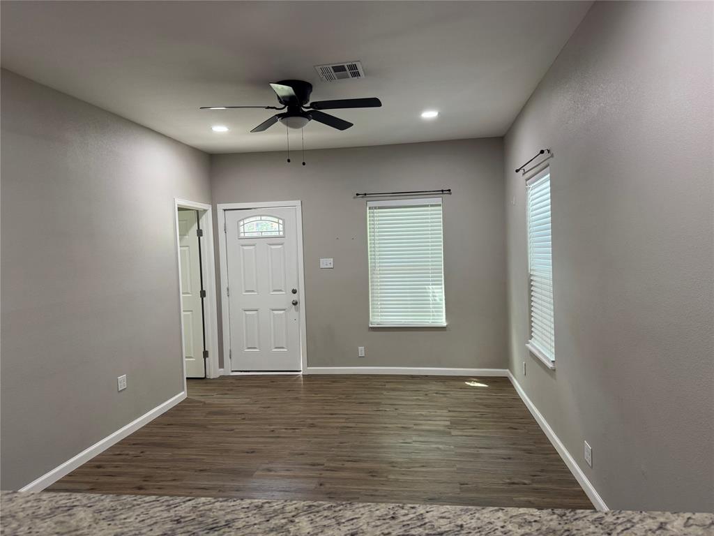 211 North Bermuda Street Lacy-Lakeview, TX 76705 - Photo 11 of 23 an empty room with wooden floor and windows