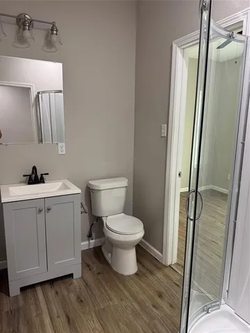 a view of a bathroom with wooden floor