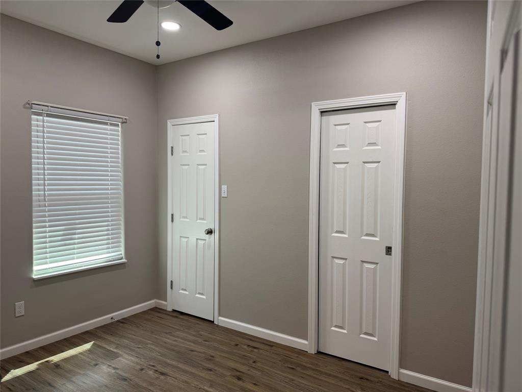 211 North Bermuda Street Lacy-Lakeview, TX 76705 - Photo 17 of 23 a view of an empty room with wooden floor and a window