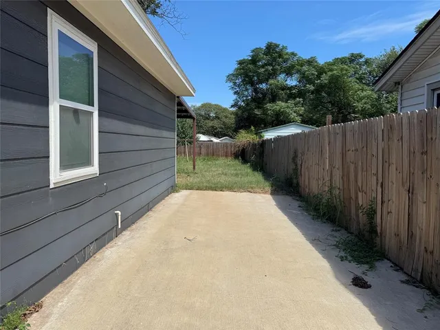 a view of a backyard with wooden fence