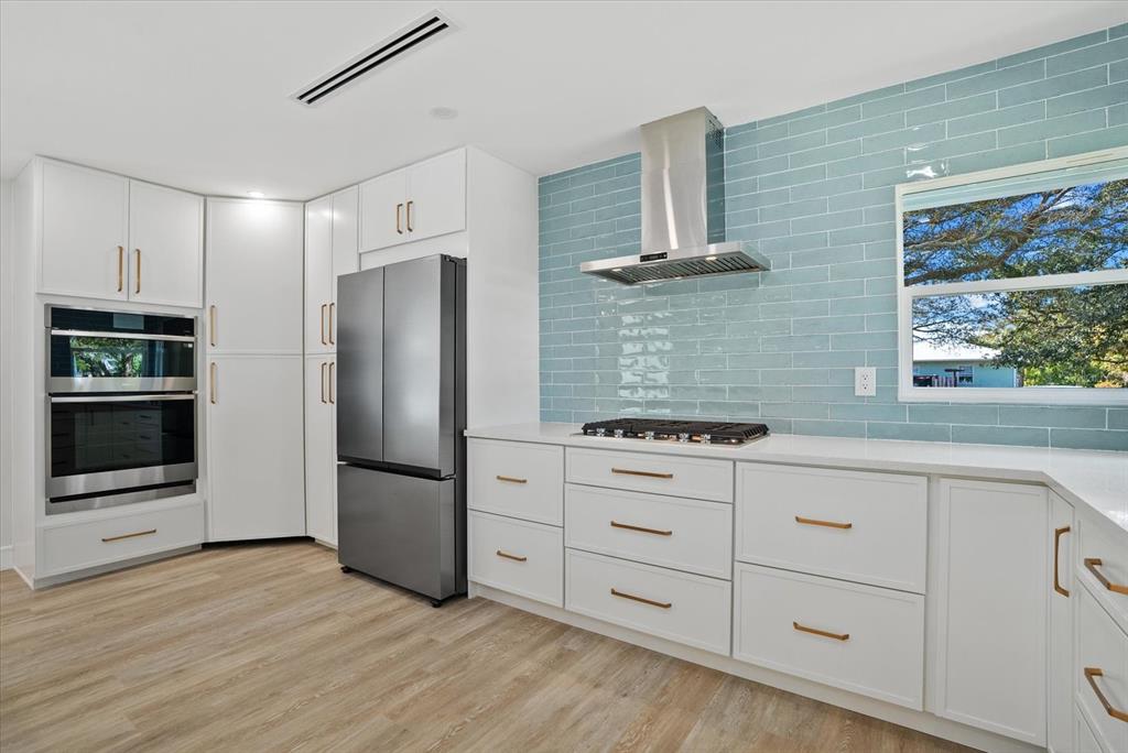 2104 Datura Street Sarasota, FL 34239 - Photo 11 of 48 a kitchen with stainless steel appliances a refrigerator and a stove top oven