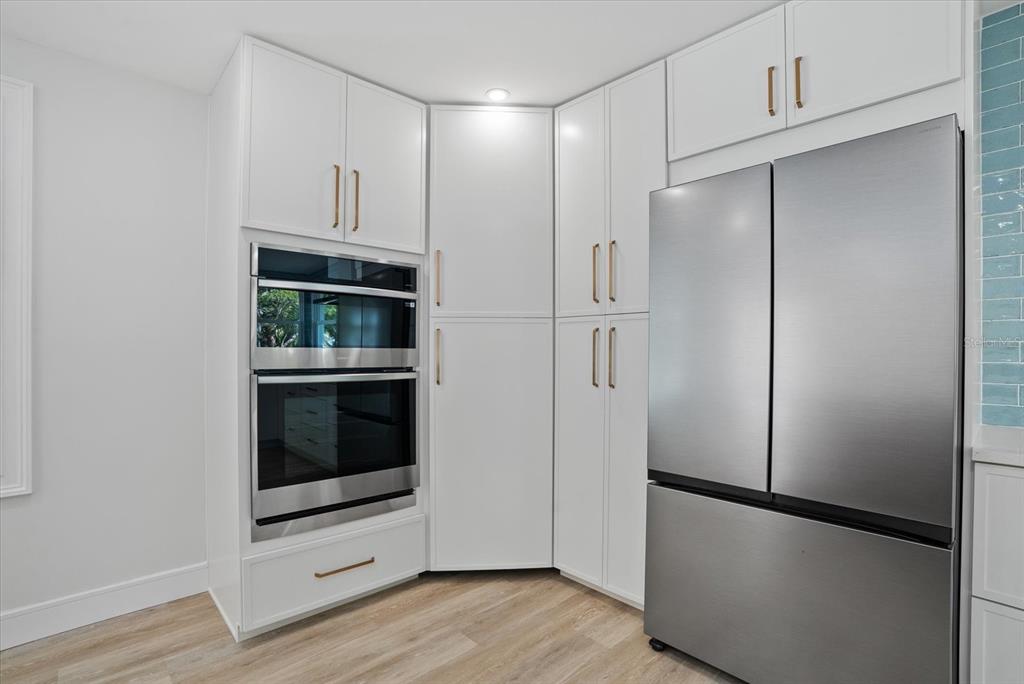 2104 Datura Street Sarasota, FL 34239 - Photo 12 of 48 a walk in closet with wooden floor
