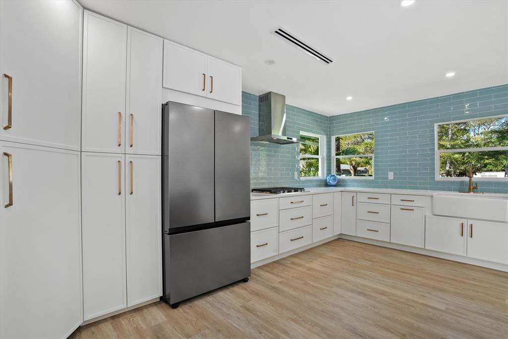 2104 Datura Street Sarasota, FL 34239 - Photo 13 of 48 a kitchen with stainless steel appliances a refrigerator sink and cabinets