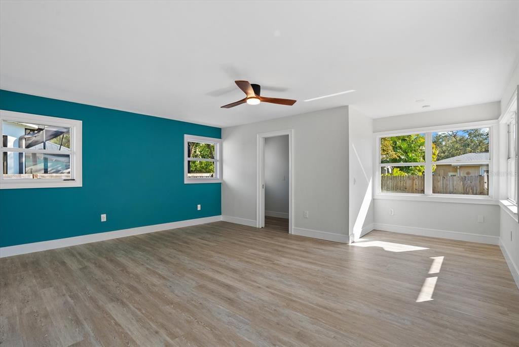 2104 Datura Street Sarasota, FL 34239 - Photo 16 of 48 a view of an empty room with a window and wooden floor