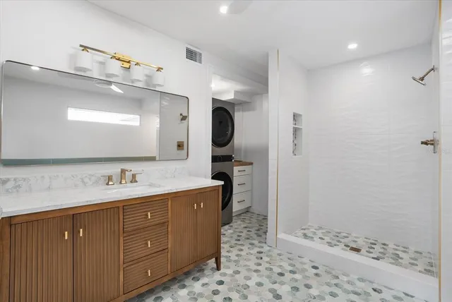 a spacious bathroom with a sink a toilet and shower