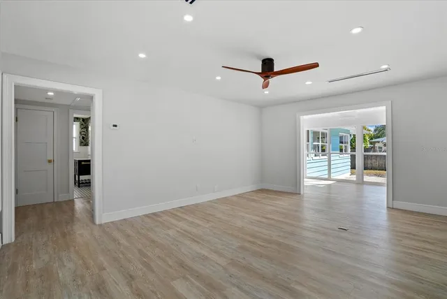 wooden floor in an empty room with a window