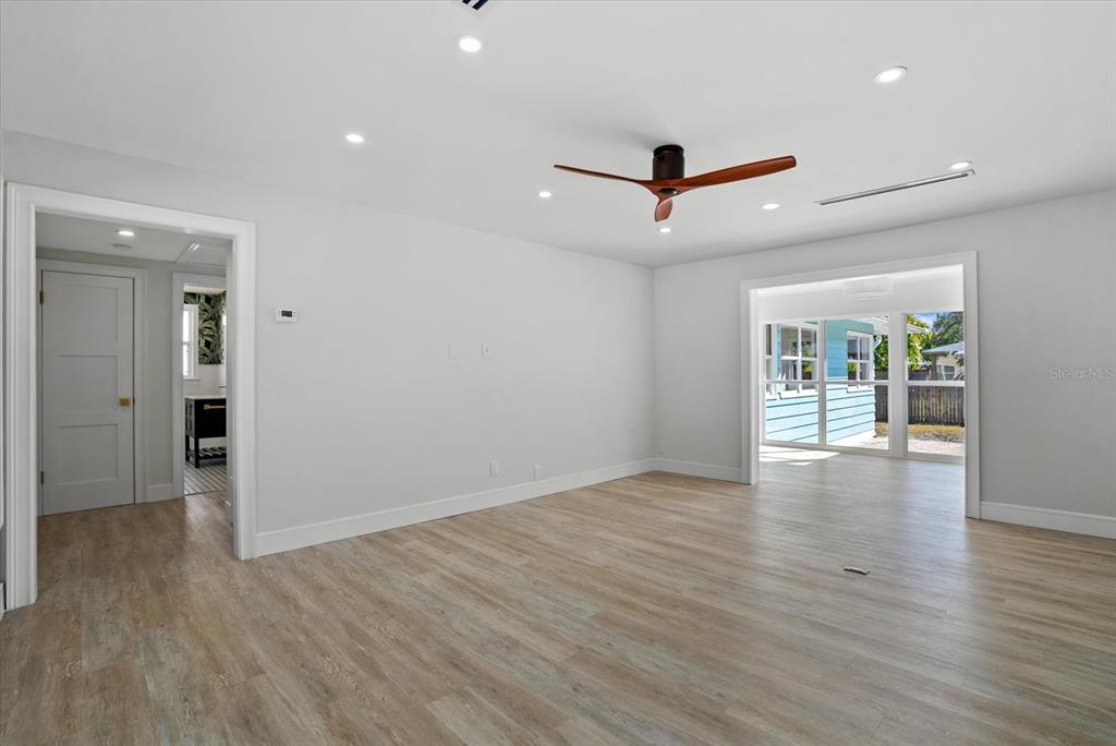 2104 Datura Street Sarasota, FL 34239 - Photo 2 of 48 wooden floor in an empty room with a window