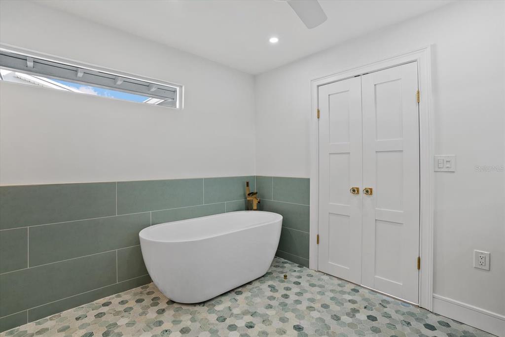 2104 Datura Street Sarasota, FL 34239 - Photo 21 of 48 a bathroom with a bathtub and shower