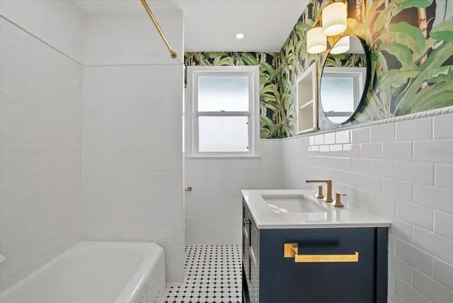 a bathroom with a sink a mirror and a bathtub