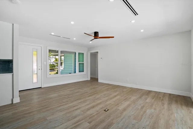 wooden floor in an empty room with a window