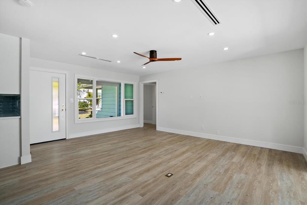 2104 Datura Street Sarasota, FL 34239 - Photo 3 of 48 wooden floor in an empty room with a window