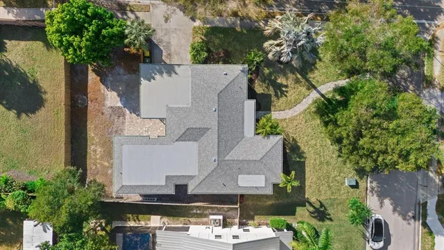 an aerial view of a house with a yard and garden