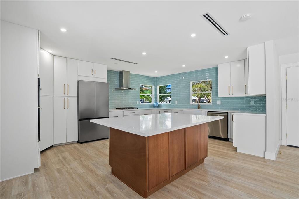 2104 Datura Street Sarasota, FL 34239 - Photo 6 of 48 a large kitchen with stainless steel appliances granite countertop a large counter top a sink and a refrigerator