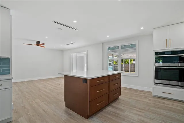 a kitchen with stainless steel appliances granite countertop a stove and a sink