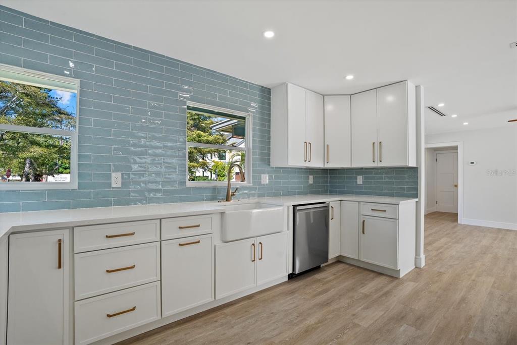 2104 Datura Street Sarasota, FL 34239 - Photo 9 of 48 a kitchen with white cabinets and window