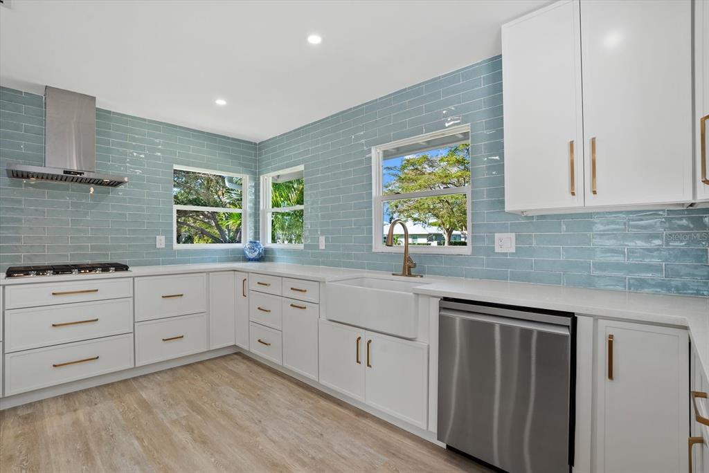 2104 Datura Street Sarasota, FL 34239 - Photo 10 of 48 a kitchen with white cabinets and window