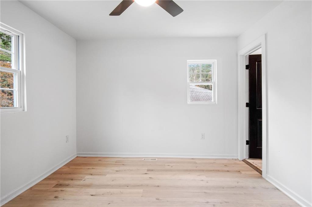 2327 El Paso Road Southwest Atlanta, GA 30331 - Photo 12 of 35 an empty room with wooden floor and windows