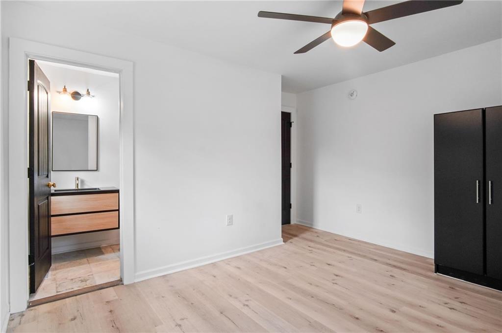 2327 El Paso Road Southwest Atlanta, GA 30331 - Photo 13 of 35 an empty room with a mirror and a ceiling fan