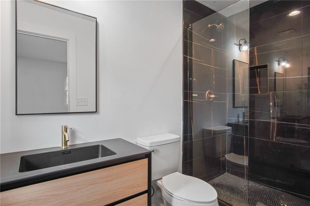 2327 El Paso Road Southwest Atlanta, GA 30331 - Photo 15 of 35 a bathroom with a sink a toilet and shower