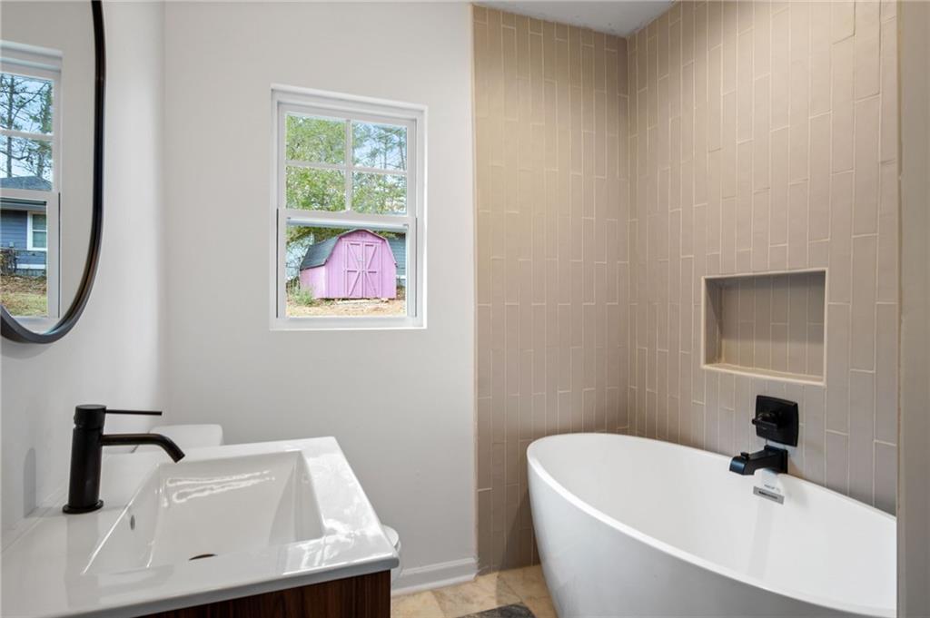 2327 El Paso Road Southwest Atlanta, GA 30331 - Photo 19 of 35 a white bath tub sitting next to a white sink