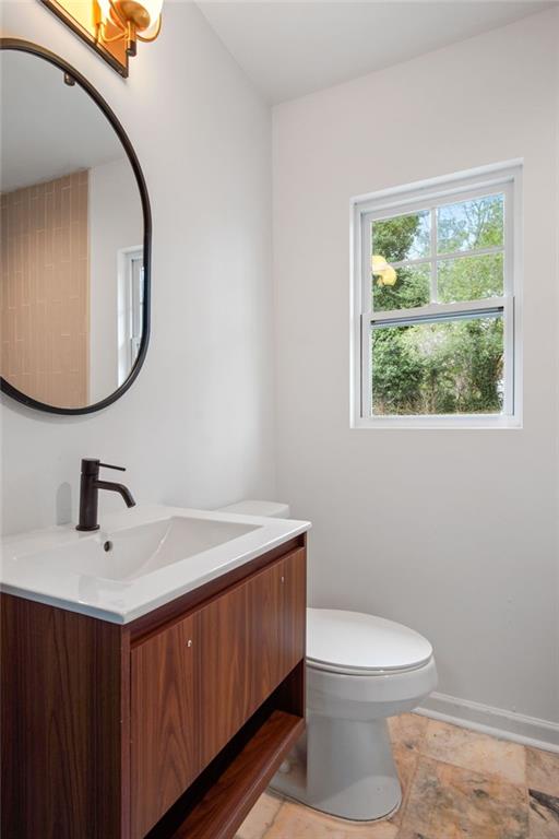 2327 El Paso Road Southwest Atlanta, GA 30331 - Photo 20 of 35 a bathroom with a toilet a sink a mirror and a window