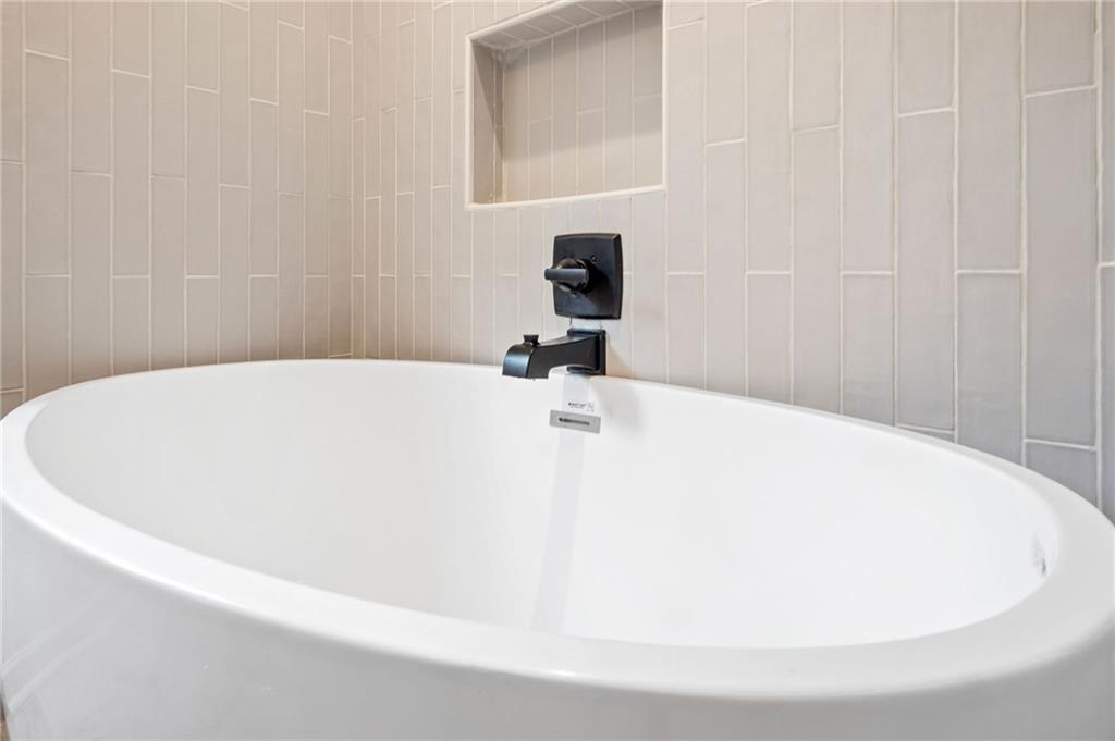 2327 El Paso Road Southwest Atlanta, GA 30331 - Photo 21 of 35 a white bath tub sitting in a bathroom