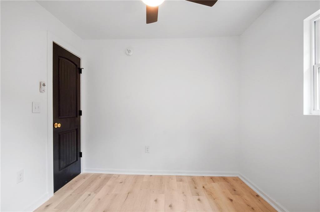 2327 El Paso Road Southwest Atlanta, GA 30331 - Photo 22 of 35 an empty room with wooden floor