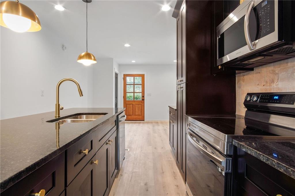 2327 El Paso Road Southwest Atlanta, GA 30331 - Photo 5 of 35 a kitchen with a sink appliances and cabinets