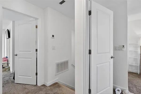 a view of a bathroom with white door