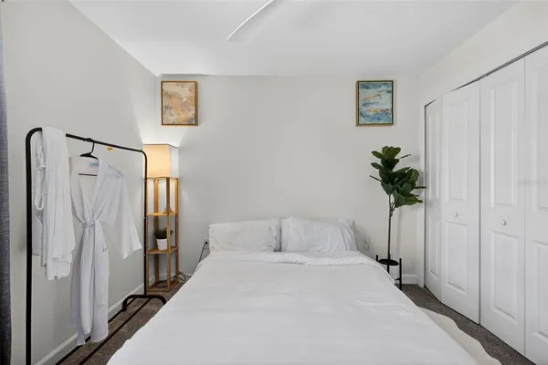 a bedroom with a bed and a potted plant