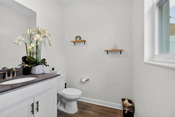 a bathroom with a toilet sink and mirror