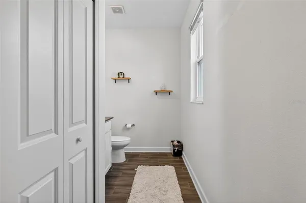 a bathroom with a granite countertop toilet and a shower