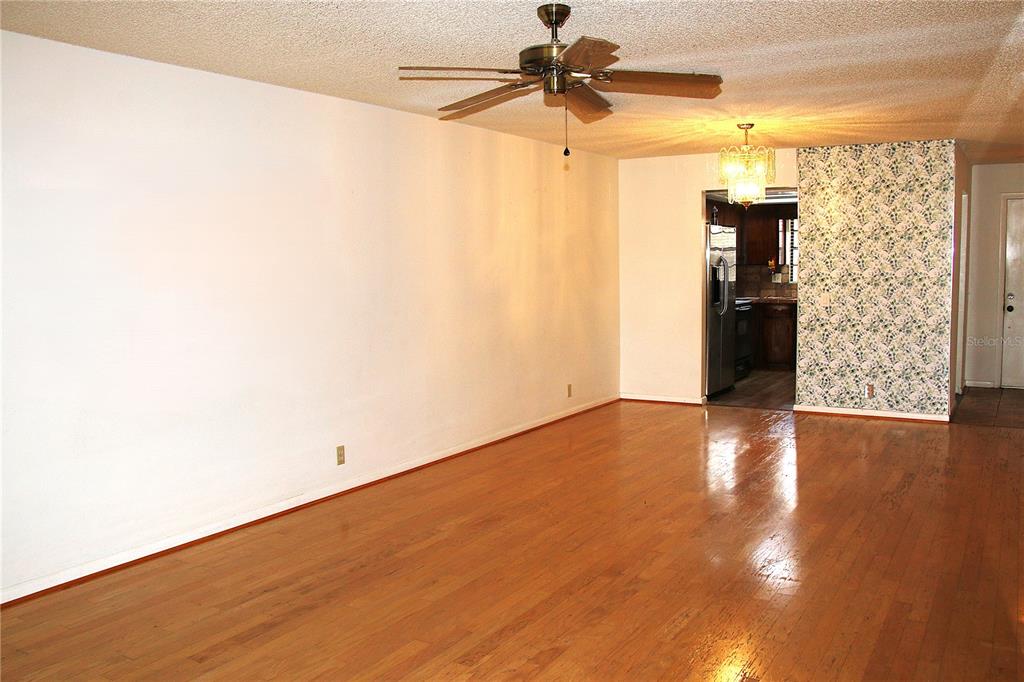 2282 Firestone Place Winter Haven, FL 33884 - Photo 11 of 34 a view of a big room with wooden floor and windows