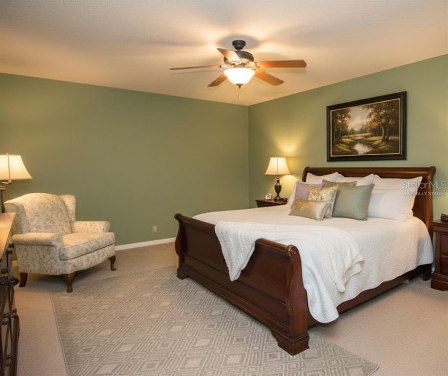 2282 Firestone Place Winter Haven, FL 33884 - Photo 20 of 34 a bedroom with a bed and a chandelier
