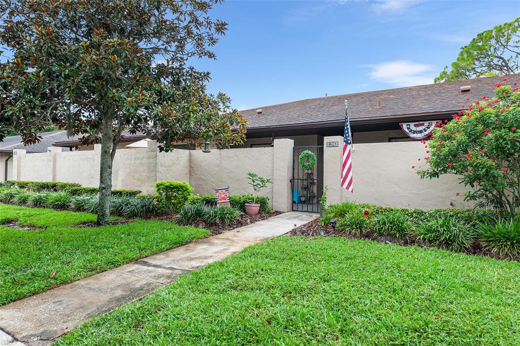 2282 Firestone Place Winter Haven, FL 33884 - Photo 2 of 34 a front view of a house with garden