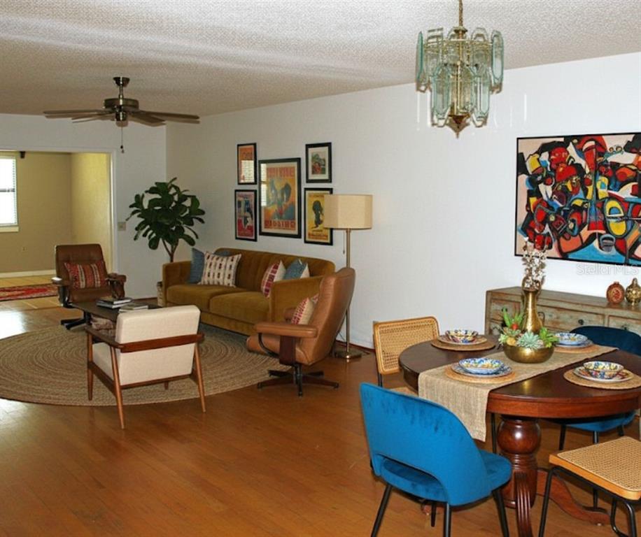 2282 Firestone Place Winter Haven, FL 33884 - Photo 9 of 34 a living room with furniture and a chandelier