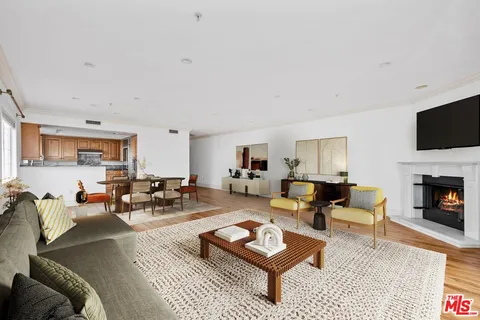 a view of empty room with wooden floor and fireplace