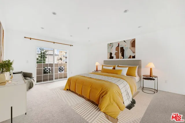 a bedroom with a large bed and a couch