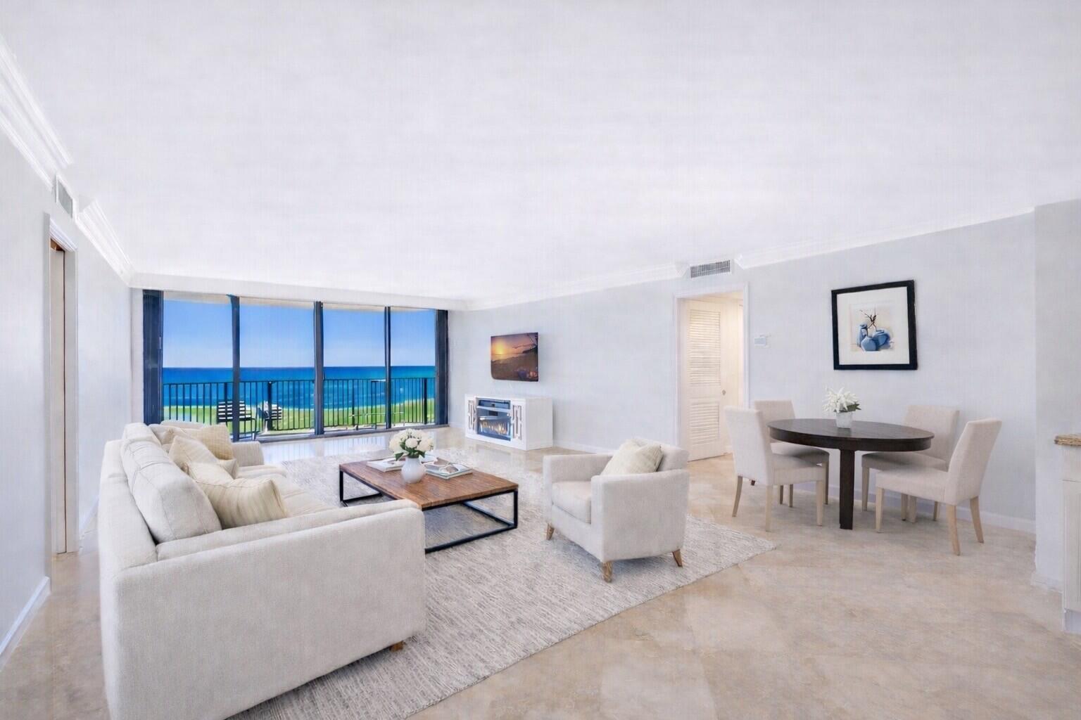 400 South Beach Road, Unit 103 Tequesta, FL 33469 - Photo 3 of 61 a living room with furniture a lamp and a floor to ceiling window