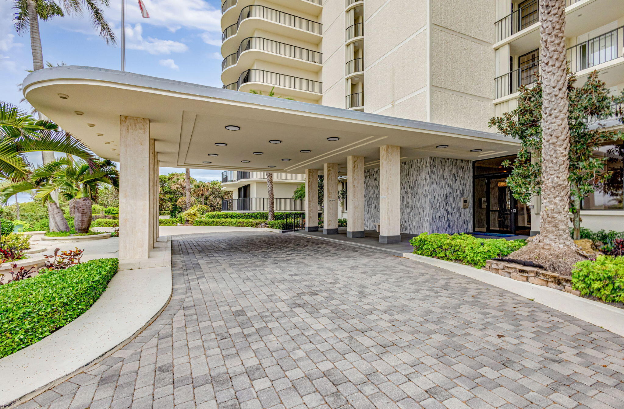 400 South Beach Road, Unit 103 Tequesta, FL 33469 - Photo 45 of 61 a view of a building with a yard