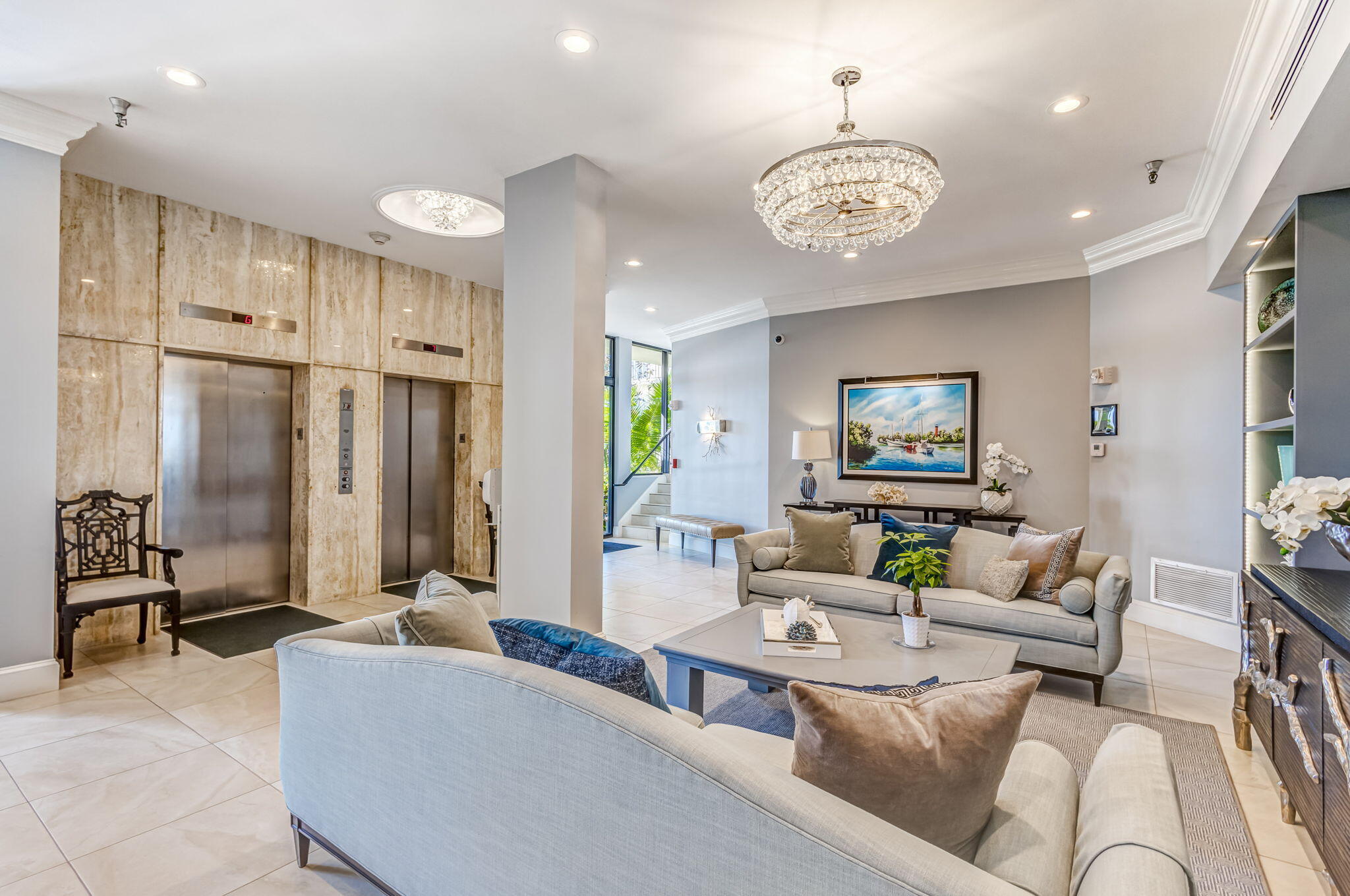 400 South Beach Road, Unit 103 Tequesta, FL 33469 - Photo 49 of 61 a living room with furniture a chandelier and a flat screen tv