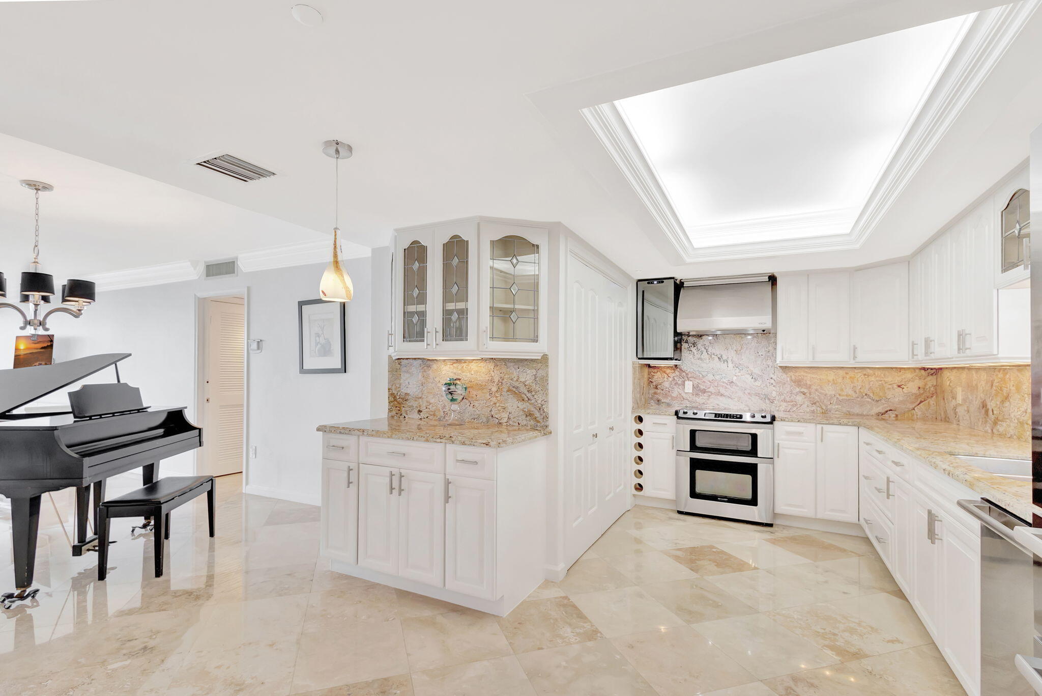 400 South Beach Road, Unit 103 Tequesta, FL 33469 - Photo 10 of 61 a kitchen with cabinets and wooden floor