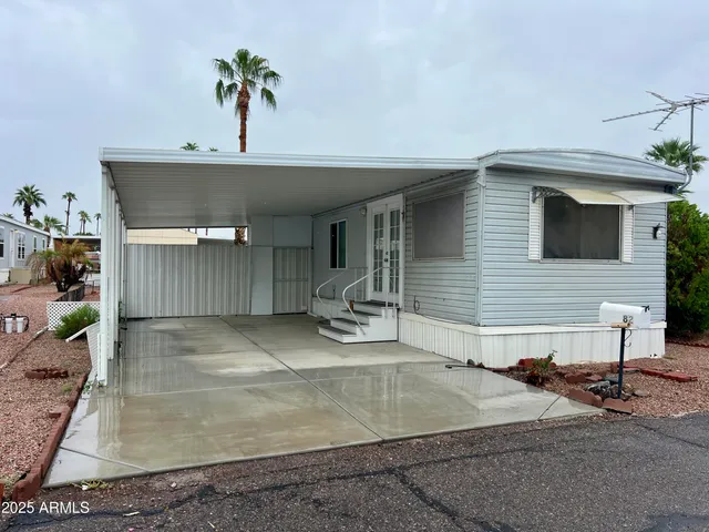 a view of a house with a patio and a yard