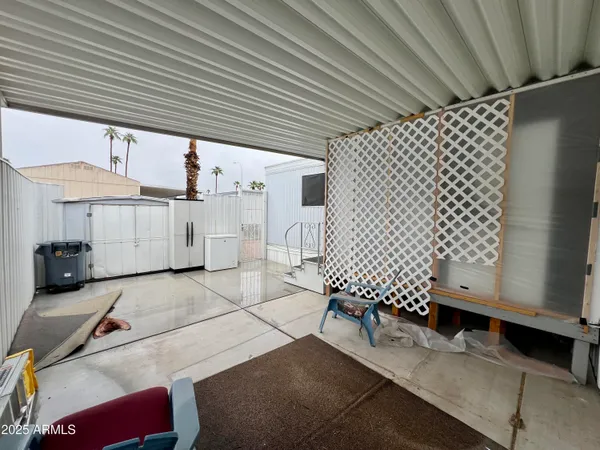 a view of a porch with furniture and wooden fence