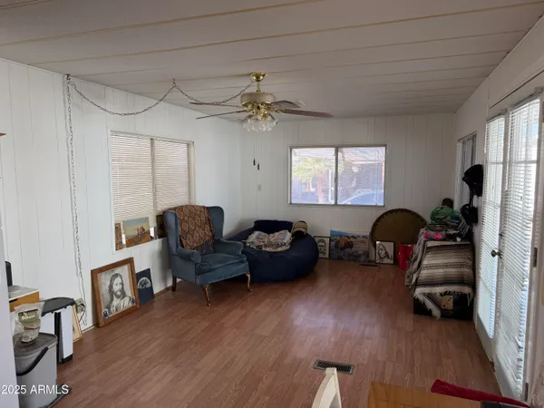 a living room with furniture and a wooden floor