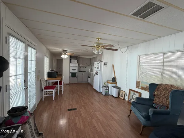 a living room with furniture and a wooden floor