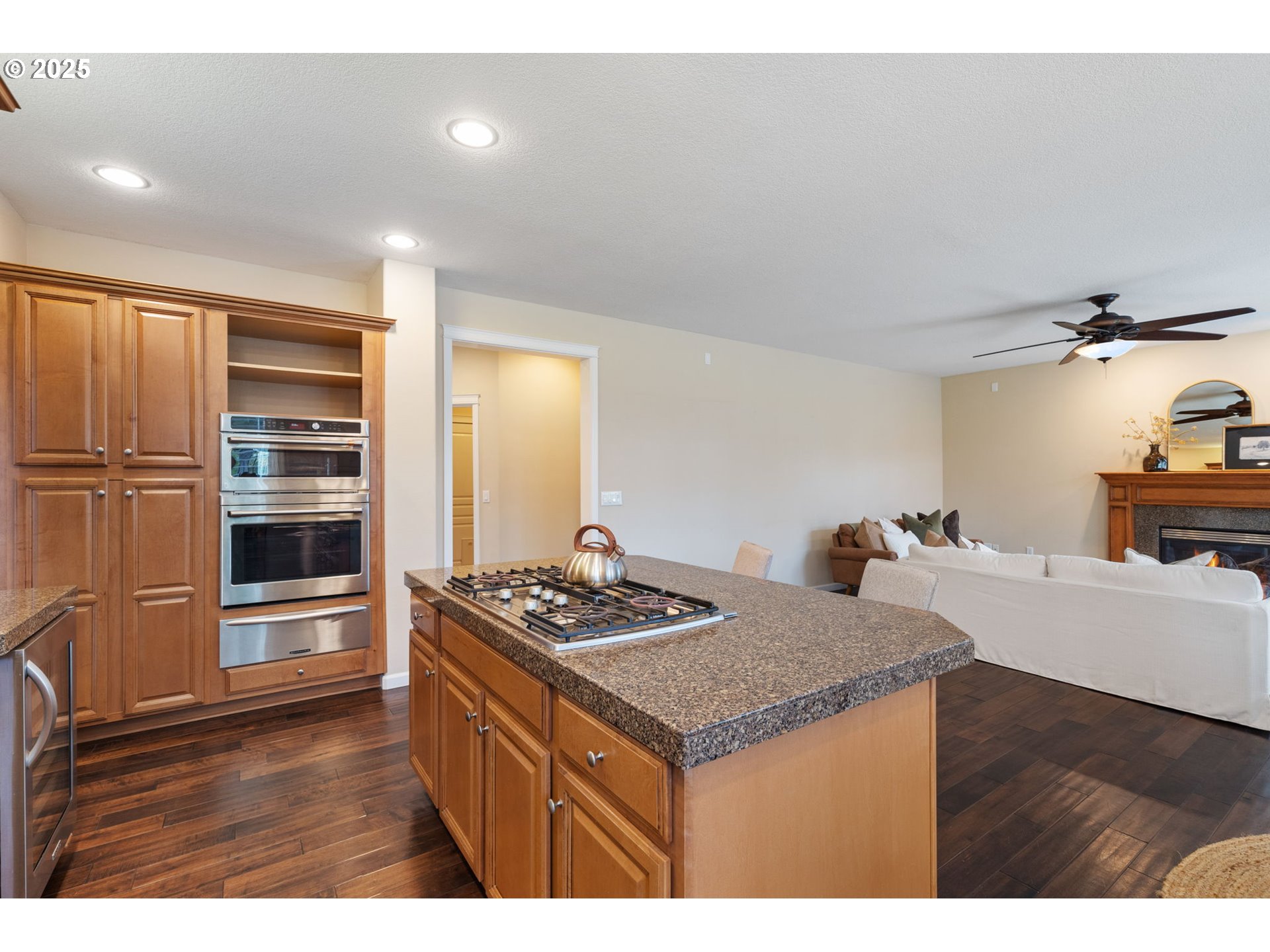1516 South Dusky Drive Ridgefield, WA 98642 - Photo 9 of 43 a kitchen that has a kitchen island wooden cabinets and stainless steel appliances