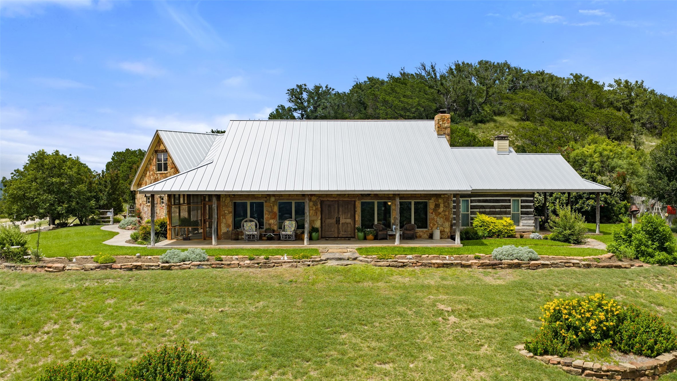 8400 Ranch Road 1431 Marble Falls, TX 78654 - Photo 25 of 30 A charming country dwelling featuring a metal roof and an inviting covered porch.