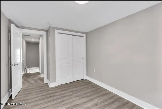a view of an empty room and wooden floor