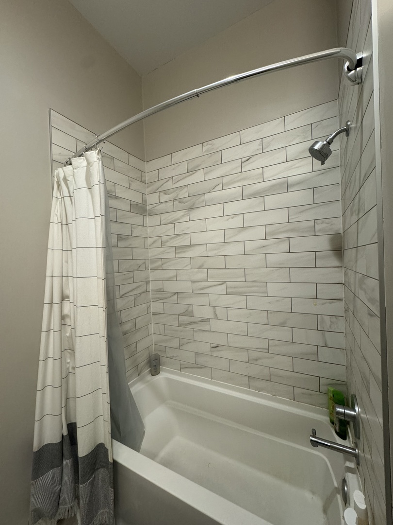 1222 West Madison Street, Unit 227 Chicago, IL 60607 - Photo 8 of 19 a bathroom with a shower and a bathtub